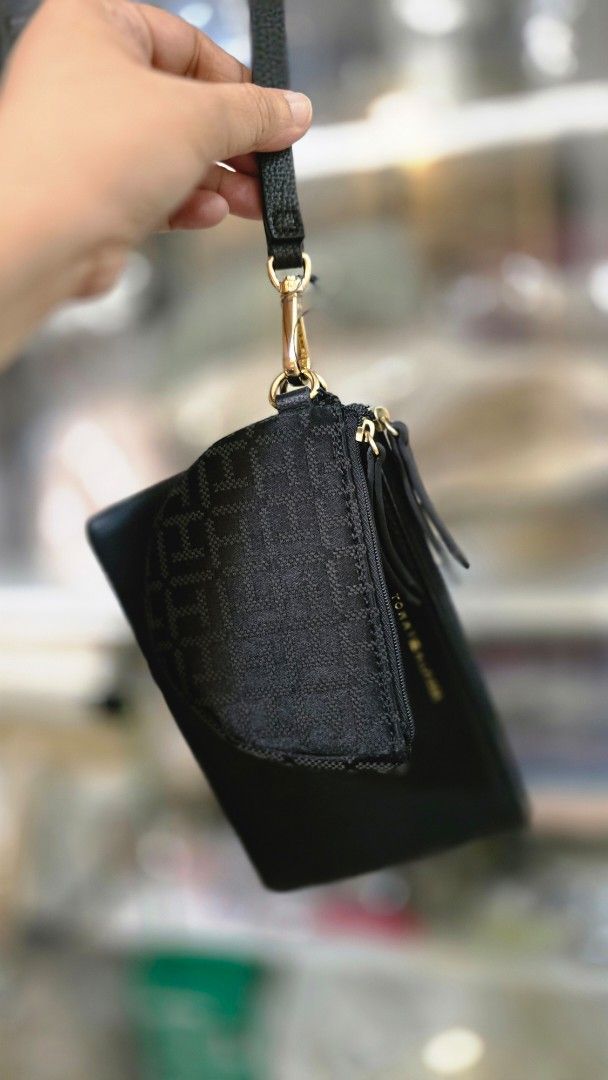 Tommy Hilfiger Black Multi-Pouch Wristlet Set (Category: Purses & Pouches) located in Quezon City. Submitted by momof3_11 (Listing ID 1468074288, Image 2). Description: - Brand: Tommy Hilfiger - Color: Classic Black with Gold-tone hardware - Set includes: Main pebbled pouch and a smaller attached monogram coin purse - Features: Removable wrist strap for versatile styling - Practical layout: Ideal for organizing cards, cash, and small daily essent