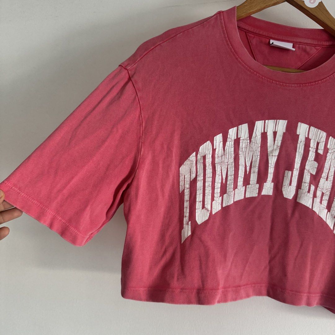 Tommy jeans crop shirt (Category: Shirts) located in Manila. Submitted by apparella.ph (Listing ID 1468135367, Image 2). Description: Selling low Used once Ung crack is design niya and faded pink tlga actual color. Keep ko sana kaso maliit na sakin Bought in Puerto rico pa physically sa store Originally got it for 2k++ 10/10, no flaws Bust:42 Length:17 ☑️Everything is my Own preloved / BNWT/BNWOT ☑️ not thrifted/Ukay ☑️ malukot sa picture kasi na