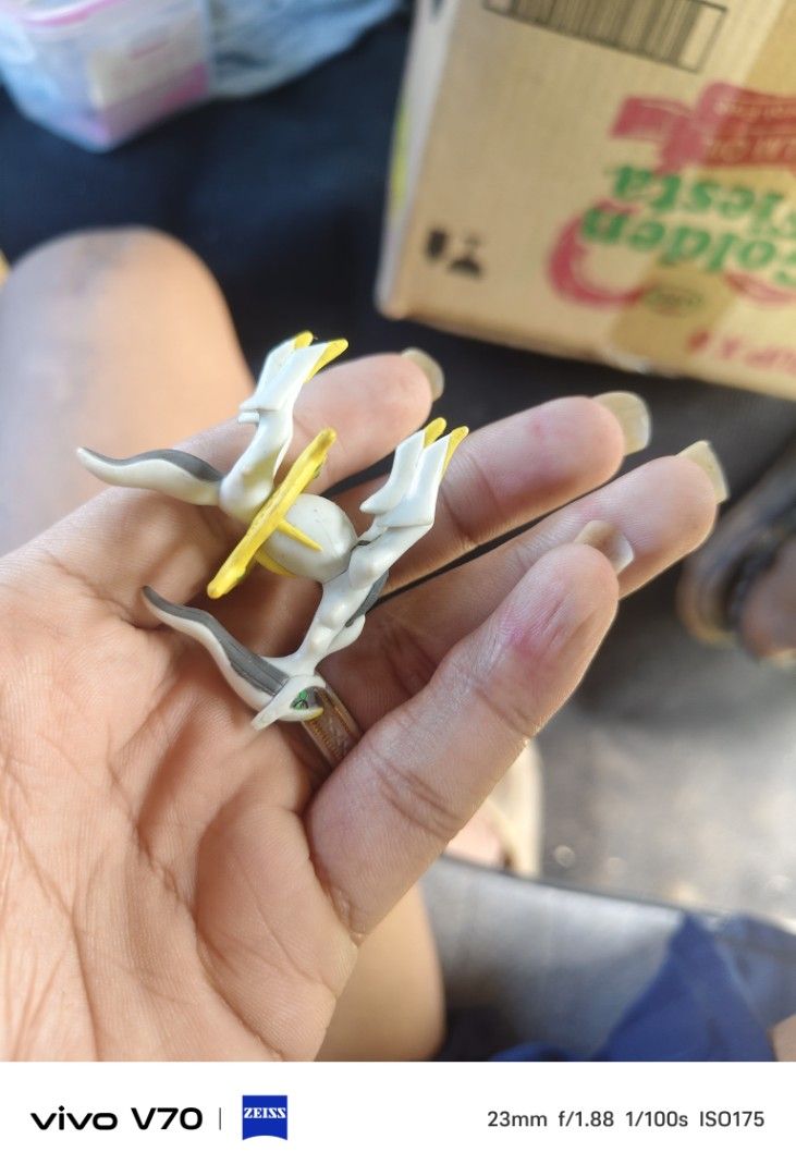 Tomy Arceus Pokemon Figure Mini Toy (Category: Figurines & Statues) located in Kapangan. Submitted by ClumZyDale (Listing ID 1468086292, Image 2). Description: - Item: Tomy Arceus Mini Figure - Design: White and gold with gray detailing - Authentic: Stamped J21 on the back - Condition: Normal signs of previous play and handling - Ideal for: Pokémon fans and toy collectors - Fulfillment: Ready to ship out or meet up.