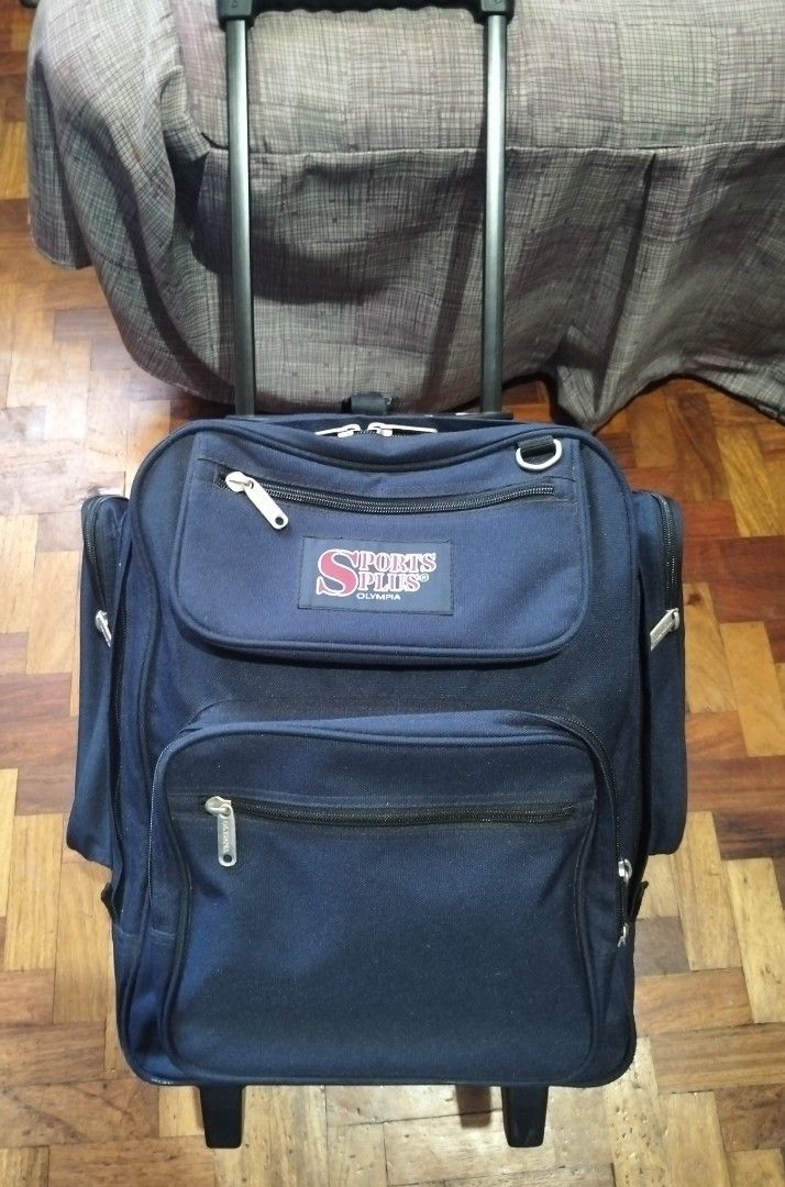 Trolley backpack wheeled by Olympia (Category: Travel Essentials & Accessories) located in Manila. Submitted by bethistama04142 (Listing ID 1468117935, Image 1). Description: - Brand: Olympia Sports Plus - Color: Blue - Condition: Good, well-maintained - Features: Retractable handle with smooth-rolling wheels - Versatility: Convertible design with hidden backpack straps - Storage: Spacious main compartment and multiple zippered outer pockets.