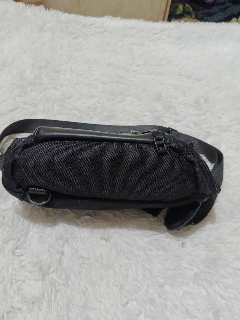 Tumi Black Nylon Waist Pack Sling Bag (Category: Sling Bags) located in Quezon City. Submitted by jdwoah12 (Listing ID 1468070138, Image 2). Description: - Brand: Tumi - Color: Classic Black - Material: Durable ballistic nylon with premium leather trim - Hardware: Sleek gunmetal hardware - Storage: Multiple zippered compartments to keep your small items organized - Fit: Adjustable strap with sturdy buckles for comfortable wear around the waist or