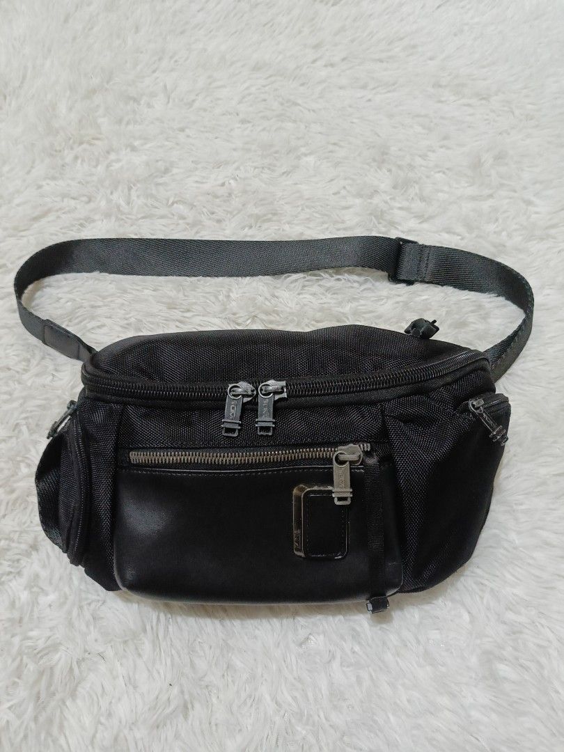 Tumi Black Nylon Waist Pack Sling Bag (Category: Sling Bags) located in Quezon City. Submitted by jdwoah12 (Listing ID 1468070138, Image 1). Description: - Brand: Tumi - Color: Classic Black - Material: Durable ballistic nylon with premium leather trim - Hardware: Sleek gunmetal hardware - Storage: Multiple zippered compartments to keep your small items organized - Fit: Adjustable strap with sturdy buckles for comfortable wear around the waist or