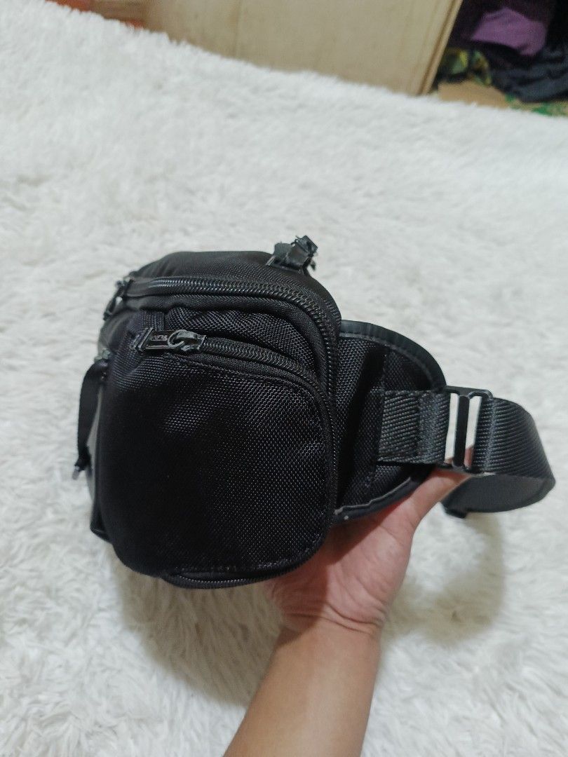 Tumi Black Nylon Waist Pack Sling Bag (Category: Sling Bags) located in Quezon City. Submitted by jdwoah12 (Listing ID 1468070138, Image 3). Description: - Brand: Tumi - Color: Classic Black - Material: Durable ballistic nylon with premium leather trim - Hardware: Sleek gunmetal hardware - Storage: Multiple zippered compartments to keep your small items organized - Fit: Adjustable strap with sturdy buckles for comfortable wear around the waist or