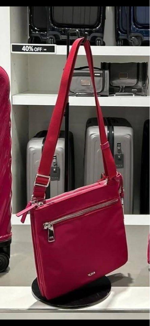 TUMI pink Nylon Crossbody Bag preloved (Category: Cross-body Bags) located in Cebu City. Submitted by cutexoxoshop (Listing ID 1468138708, Image 1). Description: - Brand: TUMI - Color: Bright red with silver-tone hardware - Material: Lightweight, durable nylon - Compartments: Multiple zip pockets on front and main body - Strap: Adjustable for a custom fit - Condition: Clean and well-maintained - Features: Subtle TUMI logo badge, great for everyda