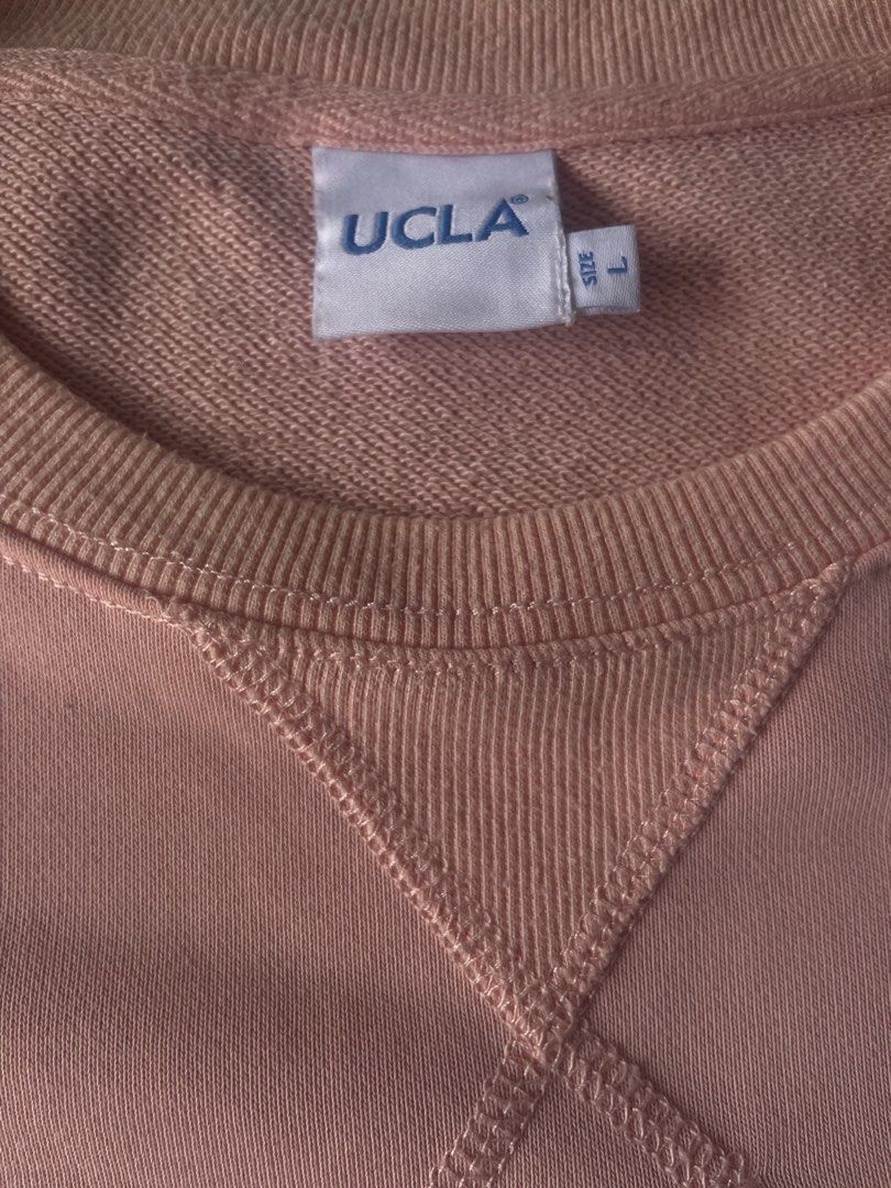 UCLA Pink Crewneck Sweatshirt Size L (Category: Coats, Jackets and Outerwear) located in Manila. Submitted by jssur (Listing ID 1468193458, Image 3). Description: - Authentic UCLA crewneck sweatshirt in a trendy pink shade - Size: L (tag attached at the neckline) - Material: 100% premium cotton for maximum comfort - Design: Features an embroidered script logo on the left chest and V-stitch collar detail - Condition: Brand new with clean interior 