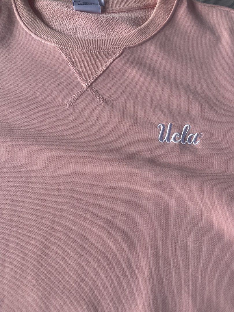 UCLA Pink Crewneck Sweatshirt Size L (Category: Coats, Jackets and Outerwear) located in Manila. Submitted by jssur (Listing ID 1468193458, Image 2). Description: - Authentic UCLA crewneck sweatshirt in a trendy pink shade - Size: L (tag attached at the neckline) - Material: 100% premium cotton for maximum comfort - Design: Features an embroidered script logo on the left chest and V-stitch collar detail - Condition: Brand new with clean interior 