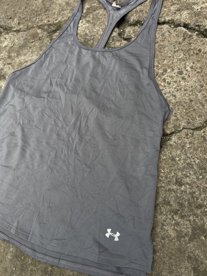 Under Armour gray racerback athletic tank top (Category: Swim Top & Rash Guards) located in Cavite. Submitted by abasolo_jv (Listing ID 1468127620, Image 3). Description: Good Condition 10/10 Color Rate No issue 18-20x26 Dimes .