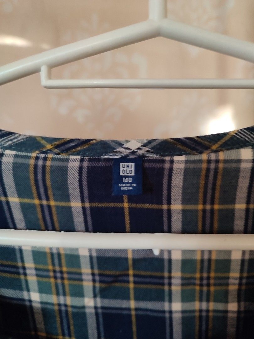 Uniqlo Plaid Dress (Category: Babies & Kids Fashion) located in Jaen. Submitted by roxantiago (Listing ID 1468249236, Image 2). Description: - Brand: Uniqlo - Style: Plaid flannel dress in blue, green, and white - Features: Long sleeves, button-front closure, side pockets, and inner black chest lining - Size: 140 (Kids) - Origin: Made in India - Condition: Great casual everyday piece can remove the black cloth upon request .