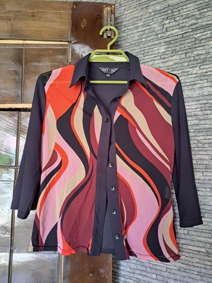 Unit One Abstract Wave Red Button-Down Blouse Y2K/Vintage (Category: Blouses) located in Iligan City. Submitted by xania_danielle03 (Listing ID 1468075813, Image 3). Description: - Brand: Unit One - Size: S (tag on collar) - Design: Colorful abstract wave pattern (orange, maroon, pink, cream) on front - Details: Solid black collar, placket, and sleeves with button-up closure - Material: Lightweight, sheer fabric.