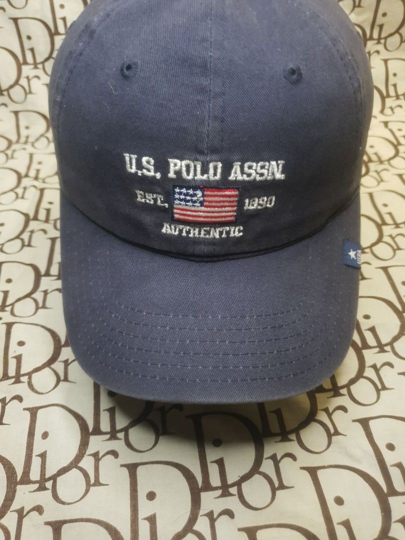 USPA NAVY BLUE BASEBALL CAP (Category: Caps & Hats) located in San Fernando. Submitted by _jaximus (Listing ID 1468218081, Image 2). Description: - Brand: U.S. Polo Assn. - Color: Classic Navy Blue - Design: Front embroidery with American flag and 'EST. 1890 AUTHENTIC' - Detailing: Small star logo patch on the left brim - Back: 'U.S. POLO ASSN.' embroidery with an adjustable metal buckle - Condition: Brand new/Excellent everyday casual hat.