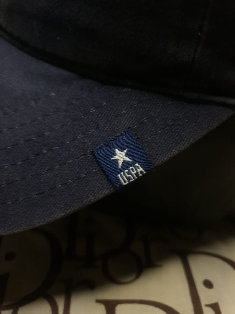 USPA NAVY BLUE BASEBALL CAP (Category: Caps & Hats) located in San Fernando. Submitted by _jaximus (Listing ID 1468218081, Image 3). Description: - Brand: U.S. Polo Assn. - Color: Classic Navy Blue - Design: Front embroidery with American flag and 'EST. 1890 AUTHENTIC' - Detailing: Small star logo patch on the left brim - Back: 'U.S. POLO ASSN.' embroidery with an adjustable metal buckle - Condition: Brand new/Excellent everyday casual hat.