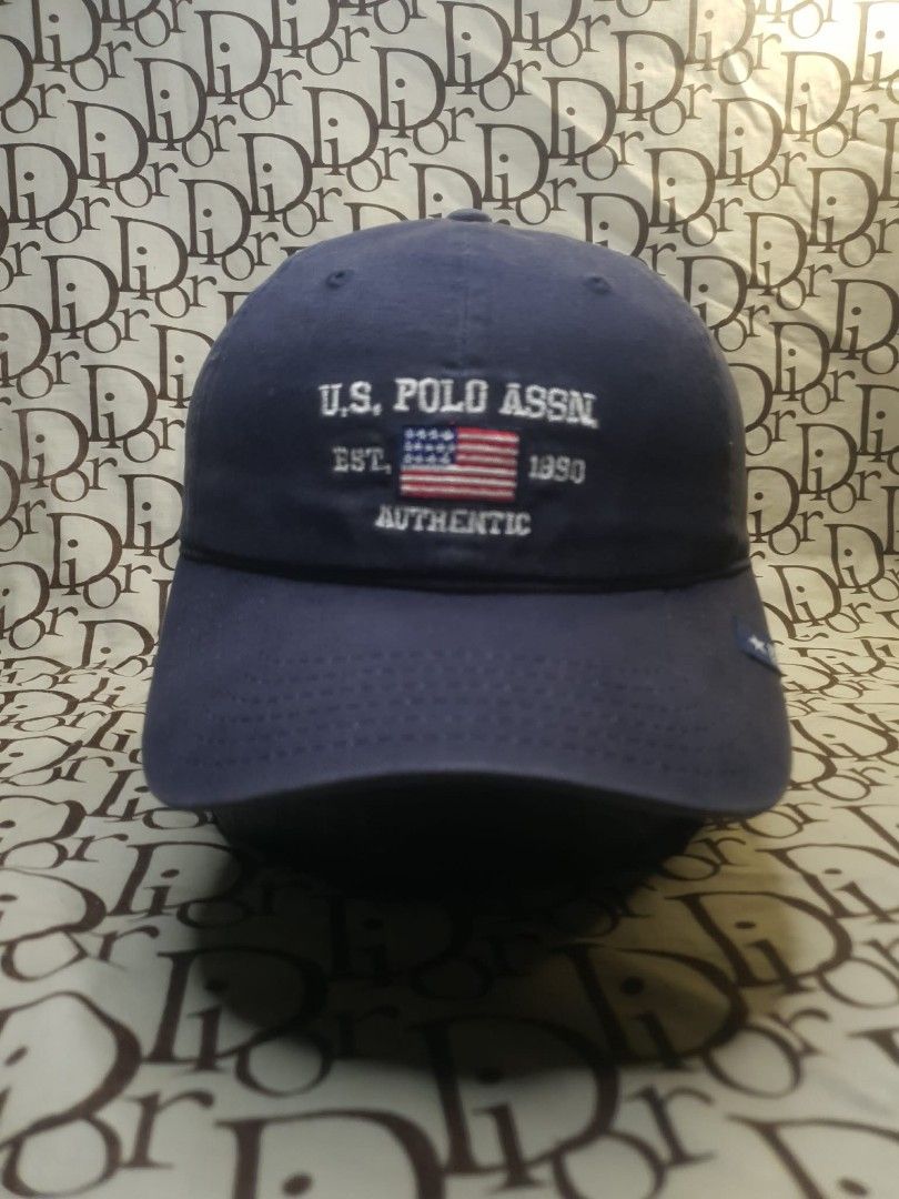 USPA NAVY BLUE BASEBALL CAP (Category: Caps & Hats) located in San Fernando. Submitted by _jaximus (Listing ID 1468218081, Image 1). Description: - Brand: U.S. Polo Assn. - Color: Classic Navy Blue - Design: Front embroidery with American flag and 'EST. 1890 AUTHENTIC' - Detailing: Small star logo patch on the left brim - Back: 'U.S. POLO ASSN.' embroidery with an adjustable metal buckle - Condition: Brand new/Excellent everyday casual hat.