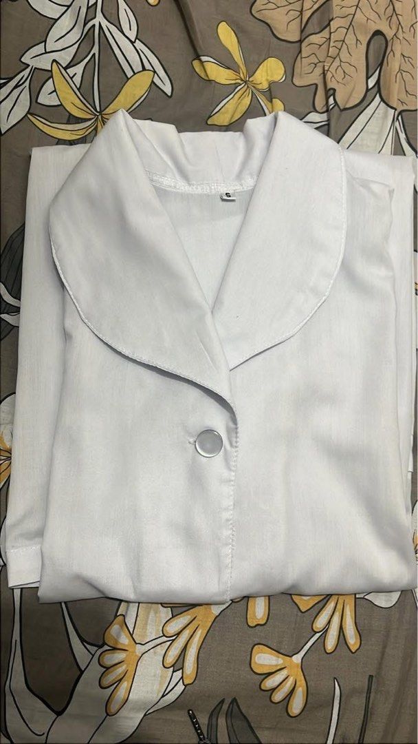 UST Nursing Female Smock Gown (Category: Sets or Coordinates) located in Manila. Submitted by monicadevera (Listing ID 1468091258, Image 2). Description: - Officially from Aling Ising - Size: Small on tag - Design: Short sleeves, rounded collar, and button-front closure (for female) - Storage: Two large front pockets for convenience - Length: Falls below the knees (depending on height).