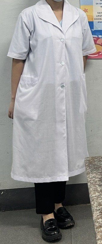UST Nursing Female Smock Gown (Category: Sets or Coordinates) located in Manila. Submitted by monicadevera (Listing ID 1468091258, Image 3). Description: - Officially from Aling Ising - Size: Small on tag - Design: Short sleeves, rounded collar, and button-front closure (for female) - Storage: Two large front pockets for convenience - Length: Falls below the knees (depending on height).