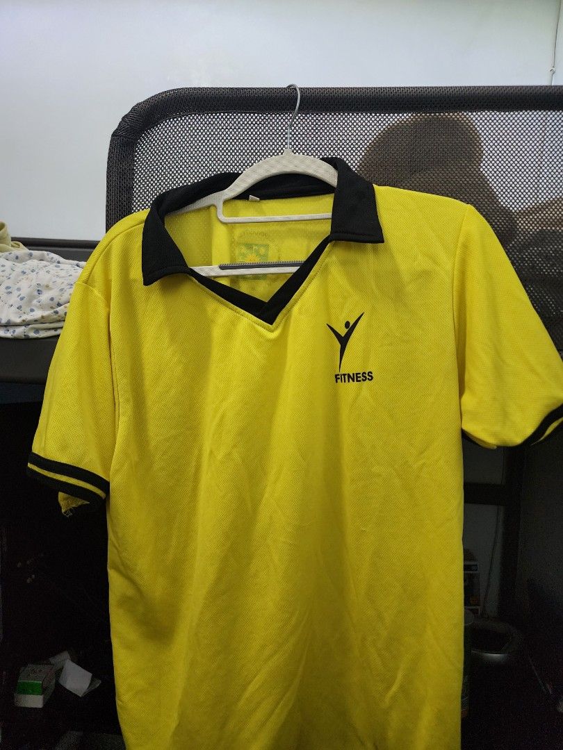 UST PATHFIT FITNESS (L) TOP ONLY (Category: Tshirts & Polo Shirts ) located in Manila. Submitted by dulayguil75827 (Listing ID 1468267593, Image 1). Description: - Color: Yellow with black collar and sleeve cuffs - Design: Printed Fitness logo on the left chest - Material: Lightweight athletic fabric - Features: Standard button placket design - Condition: Clean and ready to wear - Versatility: Perfect for workouts or casual outings.