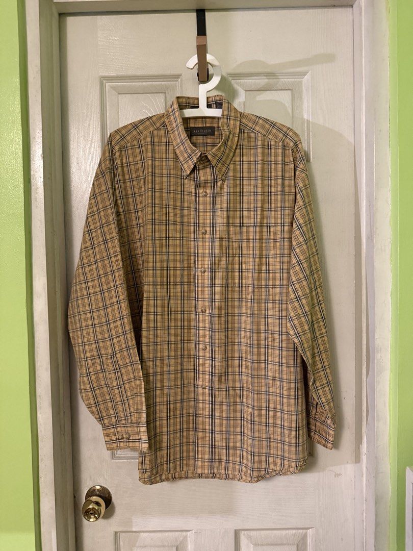 Van Heusen Tan Plaid Long Sleeve Button-Down Shirt (Category: Formal Shirts) located in Quezon City. Submitted by garythingsph (Listing ID 1468226224, Image 1). Description: Van Heusen button-down shirt in a classic tan and dark plaid pattern. Wrinkle-free fabric blend of 65% polyester and 35% cotton. Long sleeves, button-front closure, collared neckline. Size large, neck 16-16.5. Made in Cambodia. Clean condition, ready to wear for work or casua