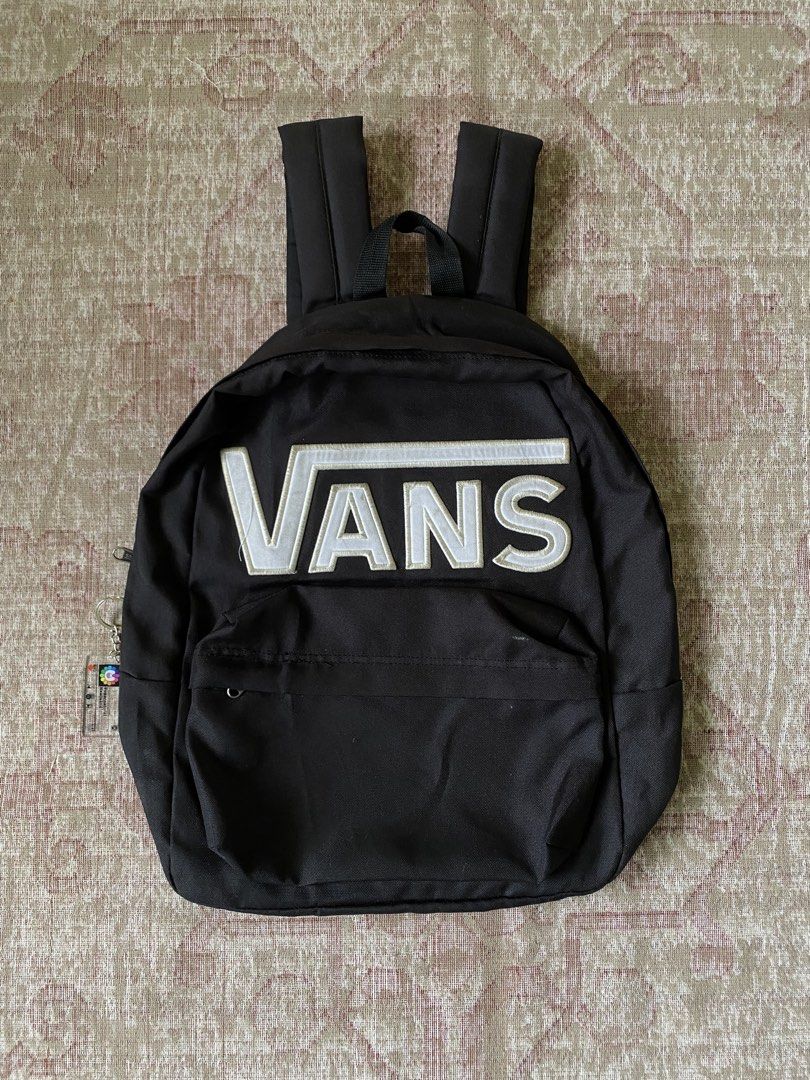 Vans Black Backpack with Embroidered Logo (Category: Backpacks) located in Manila. Submitted by diporosmoh43681 (Listing ID 1468064520, Image 1). Description: - Classic black Vans backpack with large embroidered white logo - Durable canvas material with dual zipper closures and branded metal pulls - Adjustable padded shoulder straps for comfortable everyday wear - Comes with a trendy, detachable NewJeans Supernatural keychain - Perfect standard s