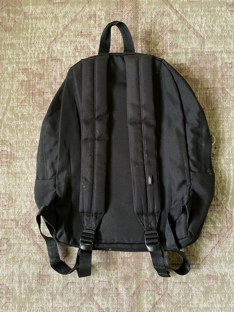Vans Black Backpack with Embroidered Logo (Category: Backpacks) located in Manila. Submitted by diporosmoh43681 (Listing ID 1468064520, Image 2). Description: - Classic black Vans backpack with large embroidered white logo - Durable canvas material with dual zipper closures and branded metal pulls - Adjustable padded shoulder straps for comfortable everyday wear - Comes with a trendy, detachable NewJeans Supernatural keychain - Perfect standard s