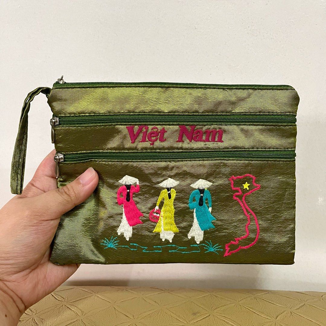 Vietnam Embroidered Green Multi-Zip Pouch (Category: Purses & Pouches) located in San Pedro. Submitted by rainyydayy (Listing ID 1468212318, Image 1). Description: - Color: Olive green with vibrant embroidery and bright blue inner lining - Design: Features three women in traditional ao dai, an outline map of Vietnam, and pink 'Viet Nam' text - Storage: 2 front zippered compartments and 1 secure main top zip closure - Portability: Comes with a han
