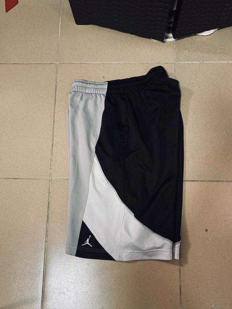 Vinatge Jordan Shorts (Category: Shorts) located in Angeles City. Submitted by jaypee2317 (Listing ID 1468123773, Image 2). Description: - Brand: Jordan - Colors: Grey, black, and white with stylish colorblock panels - Material: Breathable mesh construction for maximum comfort - Design: Iconic Jumpman logo printed near the hem - Fit: Standard fit with a comfortable stretch elastic waistband - Versatility: Ideal for workouts, basketball games, or 