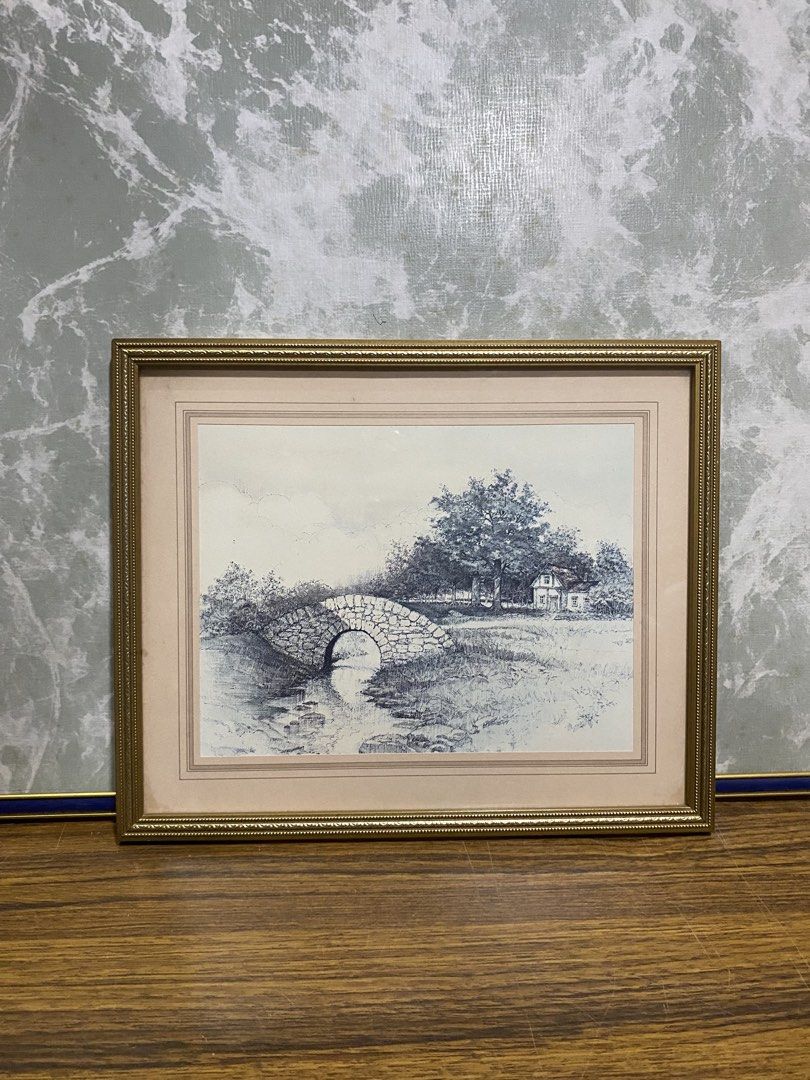 Vintage Blue Toned Landscape Print Framed (Category: Frames & Pictures) located in Calamba. Submitted by chebvintagedepot (Listing ID 1468149841, Image 1). Description: (B15-01) “Vintage Blue-Toned Landscape Print – Framed Stone Bridge and Cottage A charming vintage-style landscape print in soft blue tones, featuring a stone bridge over water, surrounded by trees and a small cottage. The artwork has a peaceful, traditional feel and would make a l