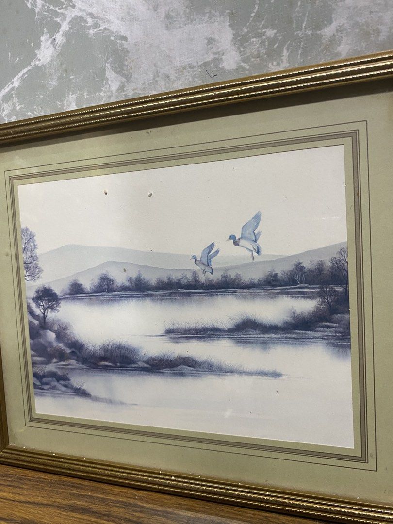 Vintage Framed Blue and White Landscape Artwork (Category: Frames & Pictures) located in Calamba. Submitted by chebvintagedepot (Listing ID 1468151834, Image 2). Description: (B15-06) “Framed Blue and White Landscape Artwork – Gold-Tone Frame This is a framed landscape artwork in calming shades of blue and white, depicting a peaceful river or shoreline with trees and two birds near the water. The artwork is finished with layered cream and pale gr