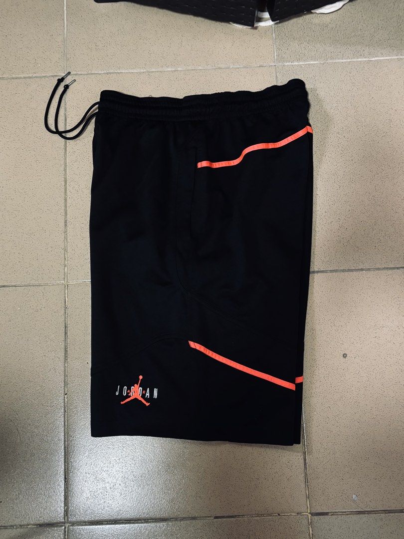 Vintage Jordan Shorts (Category: Shorts) located in Angeles City. Submitted by jaypee2317 (Listing ID 1468122914, Image 2). Description: - Brand: Jordan - Color: Black with bright orange piping and panel accents - Material: Lightweight mesh fabric - Features: Drawstring waistband with silver aglets, iconic Jumpman logo and Jordan lettering near the hem, deep side pockets - Condition: Clean, no tears or stains anywhere.