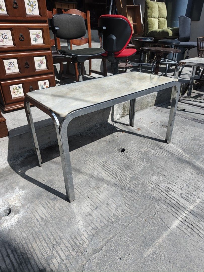 Vintage Marble Top Coffee Table with Chrome Legs (Category: Tables & Sets) located in Valenzuela. Submitted by kendra071914 (Listing ID 1468191597, Image 3). Description: - Elegant marble top with unique natural veining - Sturdy metal frame with polished chrome legs - Dimensions: 103cm (L) x 48cm (W) x 55cm (H) - Neutral tones that fit any living room or office decor.