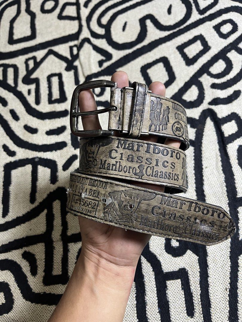 Vintage Marlboro Classics leather belt (Category: Belts) located in Silang. Submitted by yusthrift (Listing ID 1468177627, Image 1). Description: - Brand/Style: Vintage Marlboro Classics leather belt - Design: Distinctive printed graphics and text along the strap - Hardware: Includes metal buckle and loop - Condition: Distressed finish with minor scuffs from previous wear - Fit: Standard width, sturdy and rugged construction 35.5 inches.