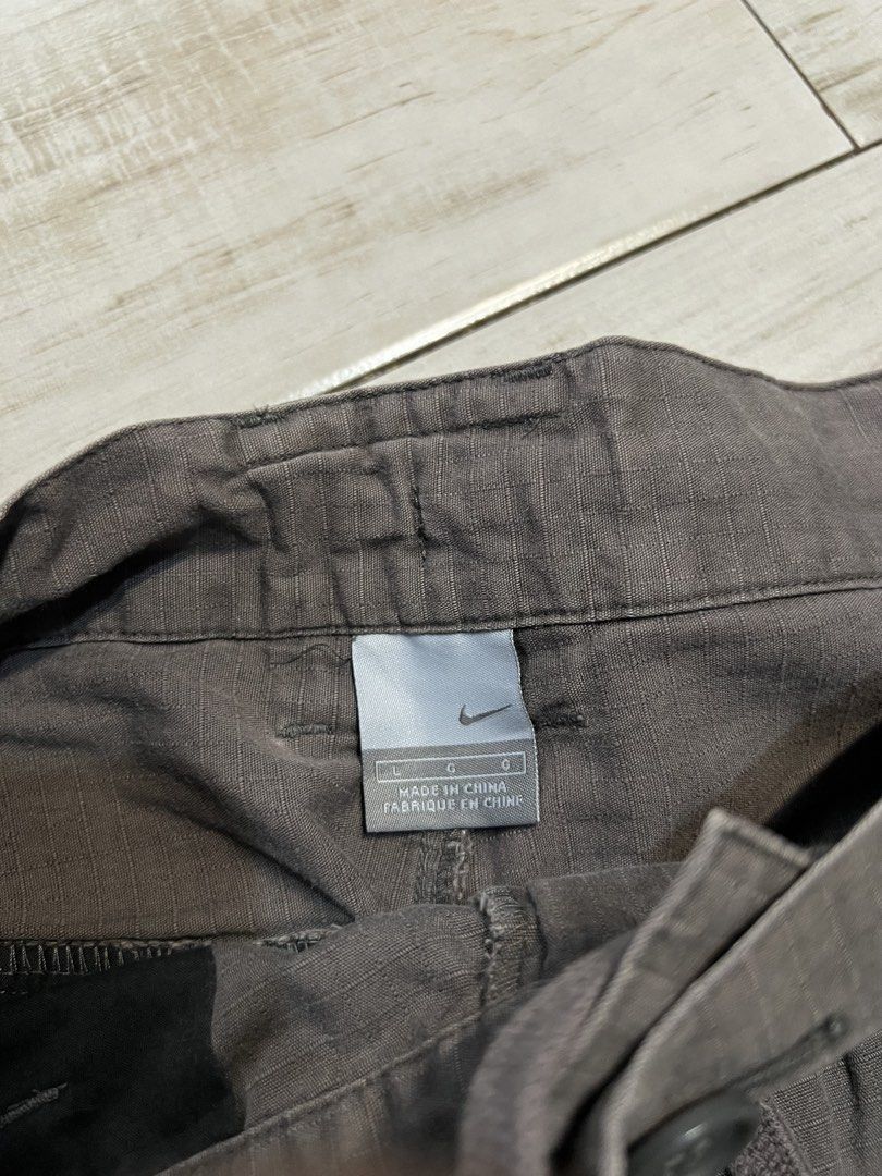 Vintage Nike Brown Cargo Trek Shorts (Category: Shorts) located in Angono. Submitted by odd.fitt (Listing ID 1468093572, Image 3). Description: Large on tag 32W 23L 12H 6 pockets Vent zips Adjustable waist With draw strings With extra buttons Embroidered swoosh and Nike script Complete tags No issue.