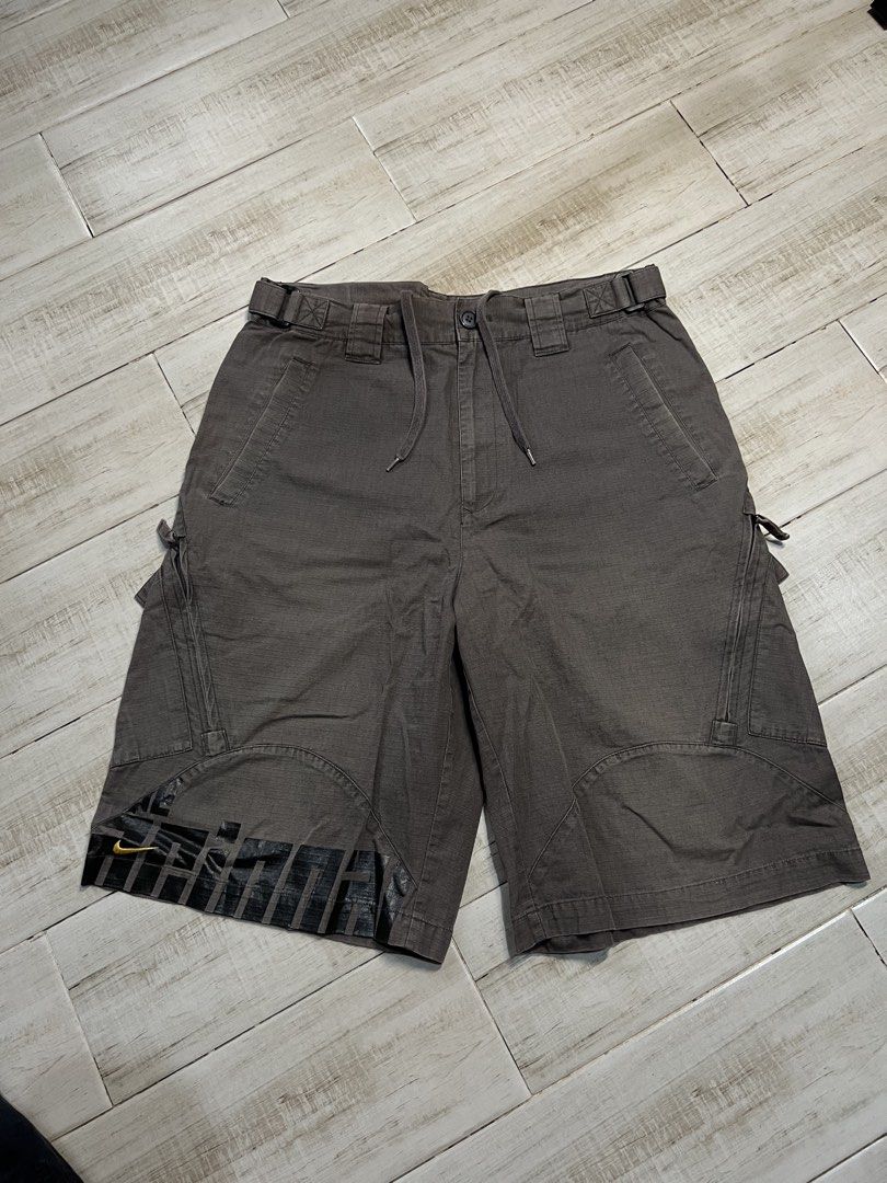 Vintage Nike Brown Cargo Trek Shorts (Category: Shorts) located in Angono. Submitted by odd.fitt (Listing ID 1468093572, Image 1). Description: Large on tag 32W 23L 12H 6 pockets Vent zips Adjustable waist With draw strings With extra buttons Embroidered swoosh and Nike script Complete tags No issue.