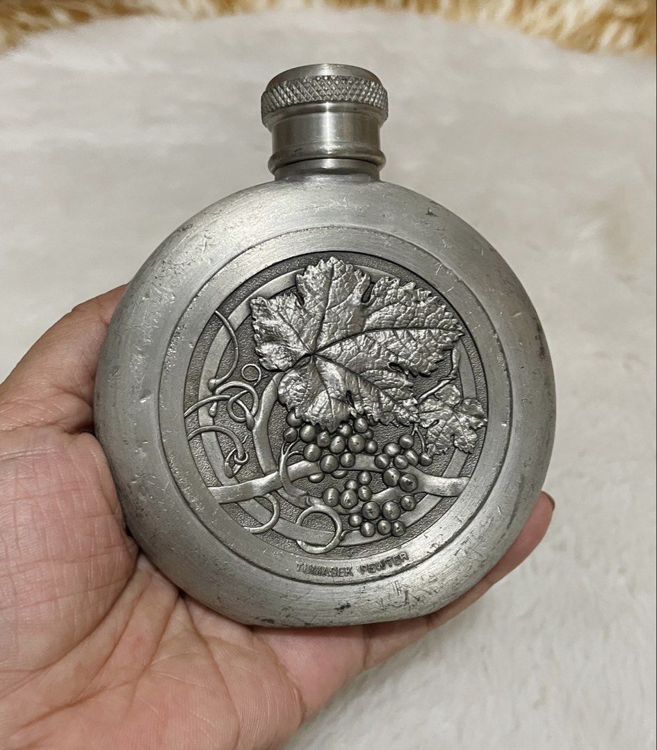 Vintage round pewter hip flask (Category: Vintage Collectibles) located in Quezon City. Submitted by sissymissy1527 (Listing ID 1468129637, Image 2). Description: Featuring a raised grape vine and leaf medallion What u see is what u get Selling as is where is Key Details: • Material: 97% pewter alloy (stamped with brand and composition details on the piece). • Design: Circular pocket/hip flask with a textured screw cap and an embossed grape clust