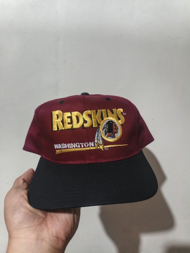 Vintage Washington Redskins NFL Snapback Hat Cap (Category: Caps & Hats) located in San Jose. Submitted by ezsenthrift475 (Listing ID 1468234109, Image 1). Description: - Official NFL Licensed Product by Twins Enterprise ('47) - Colorway: Burgundy and black panels with a classic green underbrim - Design: Raised embroidered team logo and lettering on the front - Material: 100% comfortable cotton construction, made in China - Closure: Adjustable re