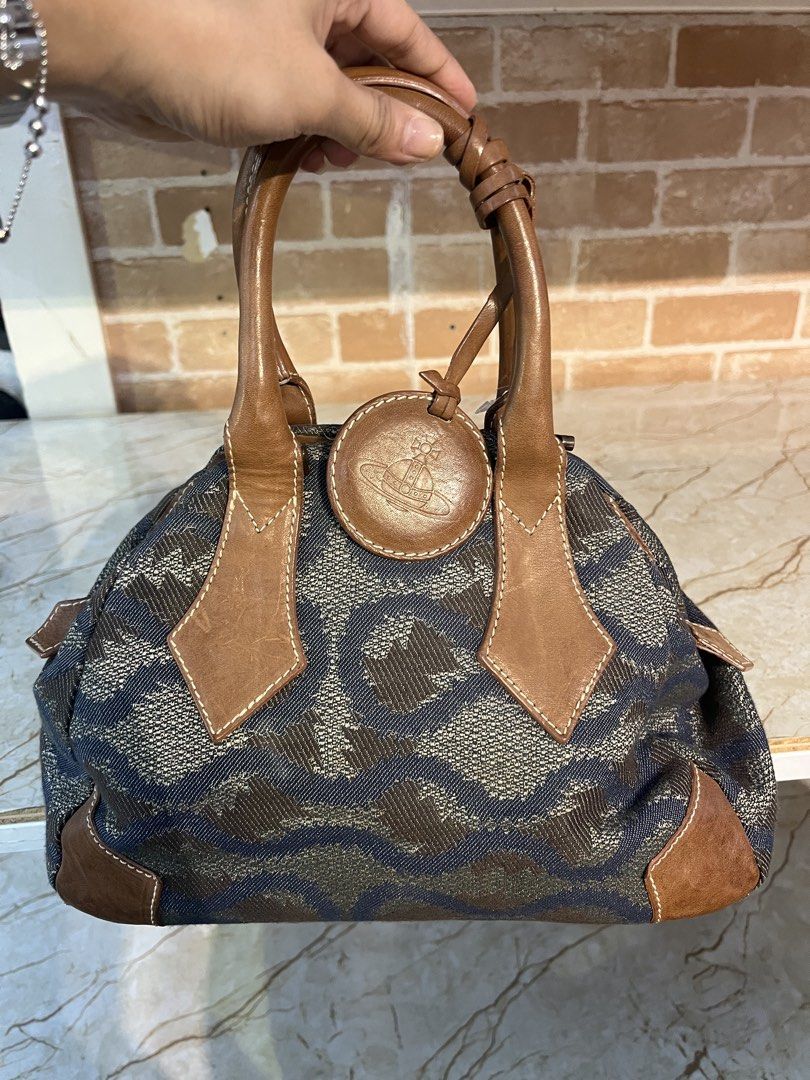 Vivienne Westwood (Category: Luxury Bags & Wallets) located in Manila. Submitted by hello_juicyyyy (Listing ID 1468279560, Image 1). Description: Vintage Vivienne Westwood Bag Fabric/Leather Approx dimensions: 21x28x12cm Good condition, hardly worn Bag shows some light wear throughout, mainly to lining, hardware, brown leather (scratches) and the bottom of the bag Please refer to all photos for the exact condition.