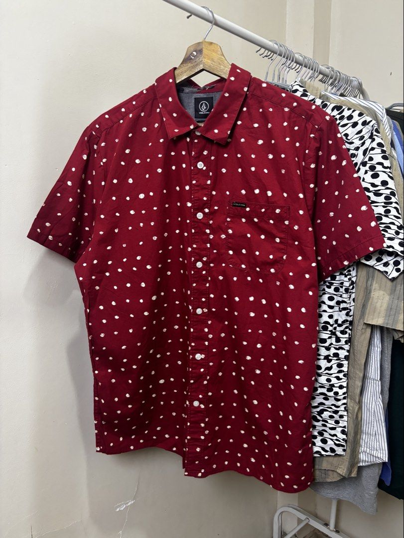 Volcom Red Polka Dot Short Sleeve Button-Down Shirt Size L (Category: Tshirts & Polo Shirts ) located in Ajuy. Submitted by galitsabarat (Listing ID 1468229586, Image 1). Description: EXCELLENT TO AS NEW CONDITION LARGE ON TAG DIMES 22.5x30 - Brand: Volcom - Style: Short sleeve button-down shirt - Color/Pattern: Rich red with all-over white polka dots - Fit: Modern fit - Size: Large (L) - Details: Standard collar, front button closure, single che