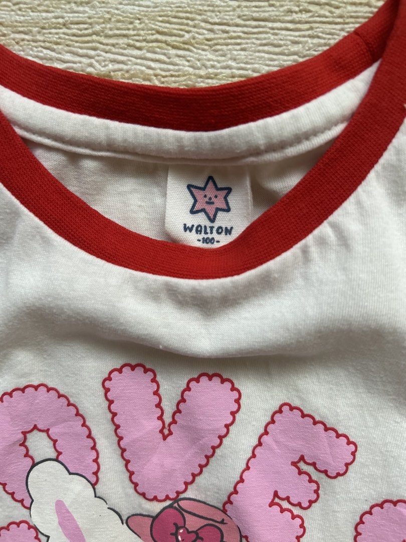 Walton puff sleeve (Category: Babies & Kids Fashion) located in Cebu City. Submitted by yjainani (Listing ID 1468068898, Image 3). Description: white and red puff-sleeve crop top features a character illustration and the word "LOVES" in pink bubble letters.