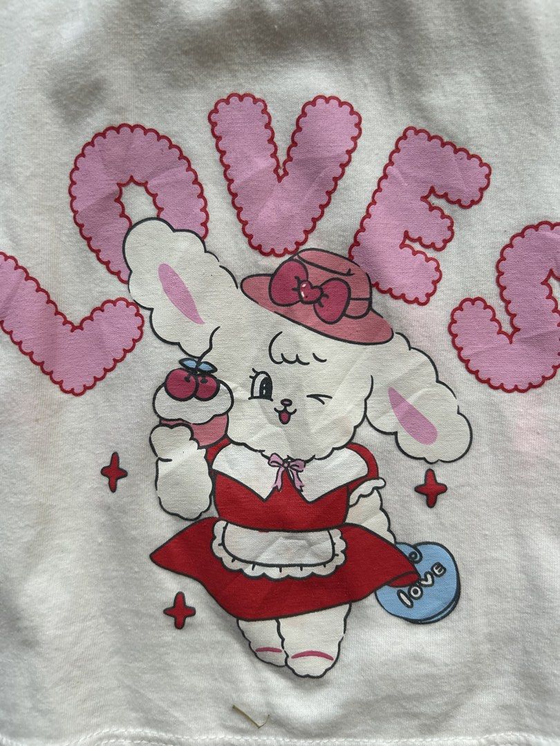 Walton puff sleeve (Category: Babies & Kids Fashion) located in Cebu City. Submitted by yjainani (Listing ID 1468068898, Image 2). Description: white and red puff-sleeve crop top features a character illustration and the word "LOVES" in pink bubble letters.