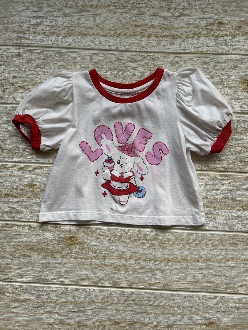 Walton puff sleeve (Category: Babies & Kids Fashion) located in Cebu City. Submitted by yjainani (Listing ID 1468068898, Image 1). Description: white and red puff-sleeve crop top features a character illustration and the word "LOVES" in pink bubble letters.