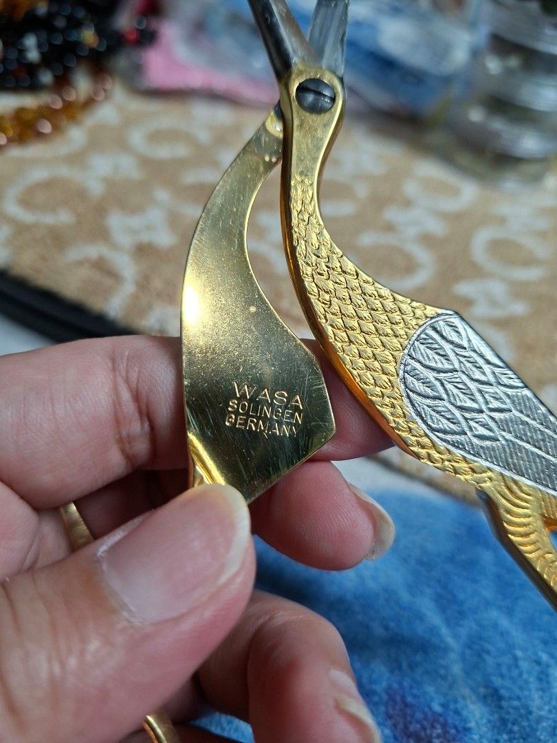 Wasa Solingen Germany Stork Embroidery Scissors (Category: Craft Supplies & Tools) located in Lucena. Submitted by dai_suki (Listing ID 1468198422, Image 3). Description: - Authentic Wasa Solingen Germany stork embroidery scissors - Stunning gold and silver tone finish with intricate scale and textured wing details - Sharp fine tip for precision crafting, sewing, and thread trimming - Rare collector's piece featuring the original maker stamp on t