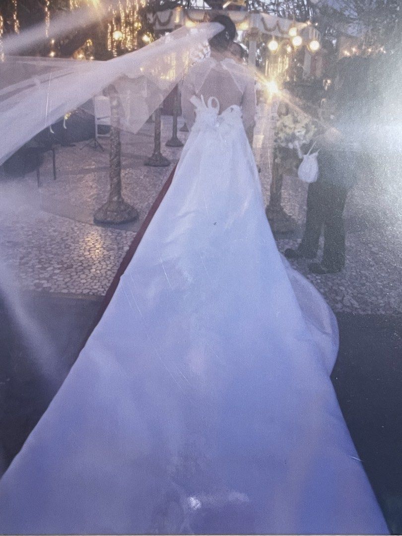 Wedding Gown (Category: Evening dresses & gowns) located in Binan City. Submitted by winds06 (Listing ID 1468206284, Image 3). Description: Selling Wedding Gown. Used. Already dry cleaned. Complete set. with trail, Cushion, Rosary cord, Veil, Wedding pouch, Guest book, candle. Size Large. See through sleeve, open back..