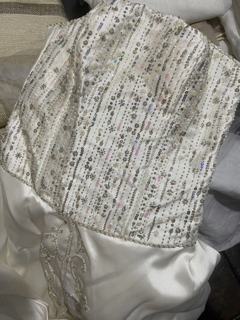 Wedding Gown (Category: Evening dresses & gowns) located in Binan City. Submitted by winds06 (Listing ID 1468208596, Image 2). Description: Selling Brandnew Wedding Gown. Tube Type. Hand beadworks frontal, back and train. Cushion included. Rosary cord.l, coins. Size: Large.