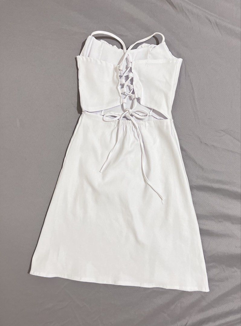 White Corset Back Ruched Bust Spaghetti Strap Mini Dress (Category: Dresses) located in Cainta. Submitted by periwinkle.ph (Listing ID 1468187715, Image 2). Description: - Color: White - Style: Mini dress with spaghetti straps and A-line skirt - Details: Ruched front bust, adjustable lace-up back with waist ties, and a small slit on the lower left - Fabric: Smooth satin-like material - Condition: Worn once for a photo shoot, no stains or damage (