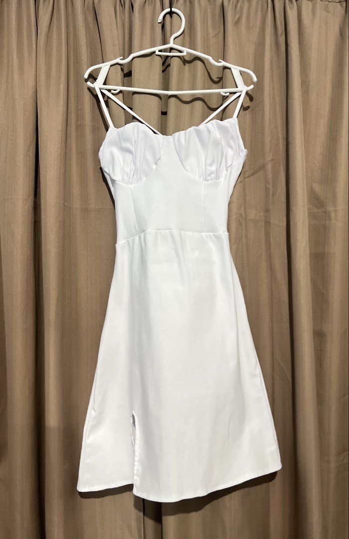 White Corset Back Ruched Bust Spaghetti Strap Mini Dress (Category: Dresses) located in Cainta. Submitted by periwinkle.ph (Listing ID 1468187715, Image 1). Description: - Color: White - Style: Mini dress with spaghetti straps and A-line skirt - Details: Ruched front bust, adjustable lace-up back with waist ties, and a small slit on the lower left - Fabric: Smooth satin-like material - Condition: Worn once for a photo shoot, no stains or damage (