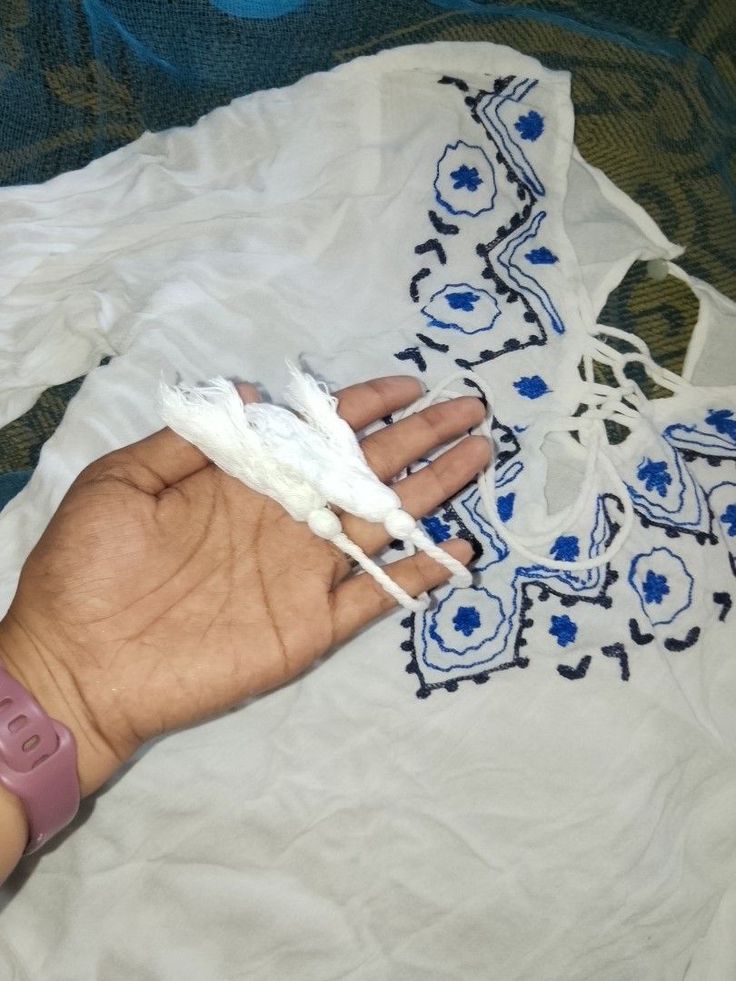 White embroided lace up boho blouse (Category: Longsleeves) located in Adams. Submitted by yelri555 (Listing ID 1468117559, Image 3). Description: TRUE LOVE White Boho Blouse - Size: Small to Medium (flowy) - White gauze cotton, blue embroidery - Lace-up neckline with tassels - Long sleeves, comfy for beach / school / daily - Condition: Good, no damage, no sign of use. needs ironing lang RFS: Declutter, nbu from package Loc: Narvacan.