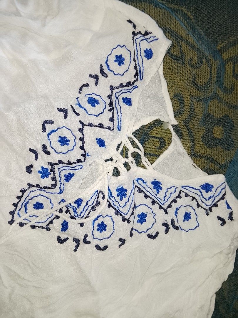 White embroided lace up boho blouse (Category: Longsleeves) located in Adams. Submitted by yelri555 (Listing ID 1468117559, Image 2). Description: TRUE LOVE White Boho Blouse - Size: Small to Medium (flowy) - White gauze cotton, blue embroidery - Lace-up neckline with tassels - Long sleeves, comfy for beach / school / daily - Condition: Good, no damage, no sign of use. needs ironing lang RFS: Declutter, nbu from package Loc: Narvacan.