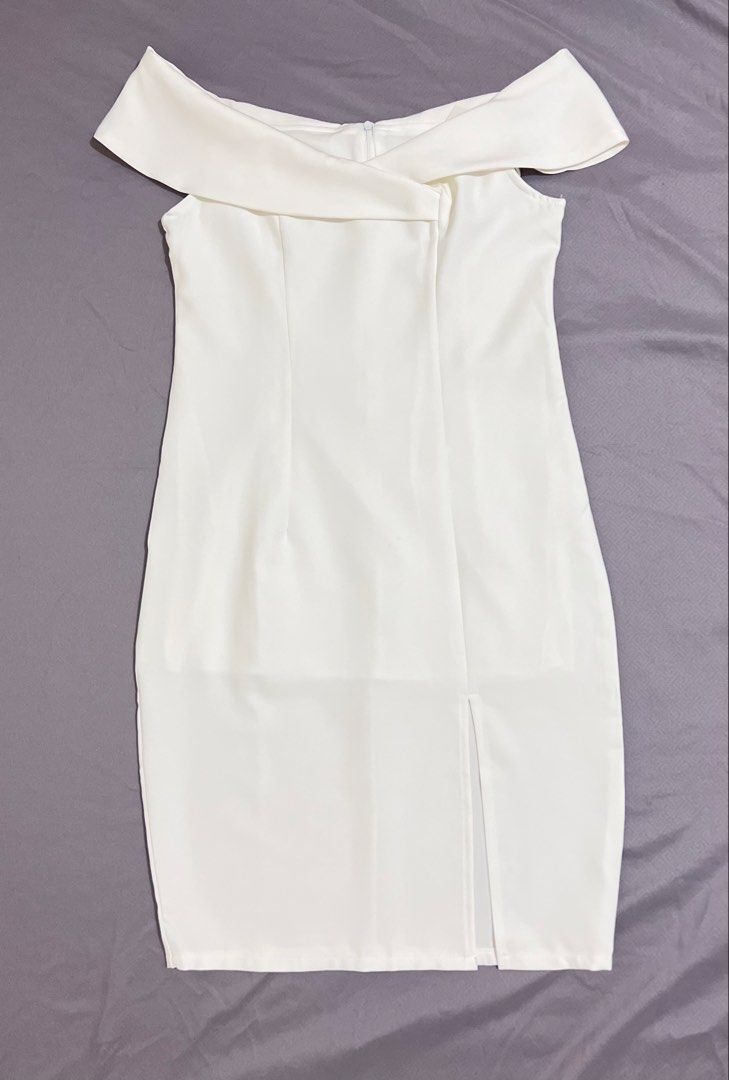 White off-shoulder bodycon dress with front slit (Category: Dresses) located in Cainta. Submitted by periwinkle.ph (Listing ID 1468189390, Image 1). Description: - Style: Off-shoulder bodycon midi dress - Design: Foldover neckline with chic front crossover detail - Fit: Form-fitting silhouette with a subtle front leg slit - Closure: Secure back zipper - Color: Clean, solid white - Condition: Brand new / Excellent quality - Perfect for: Parties, d