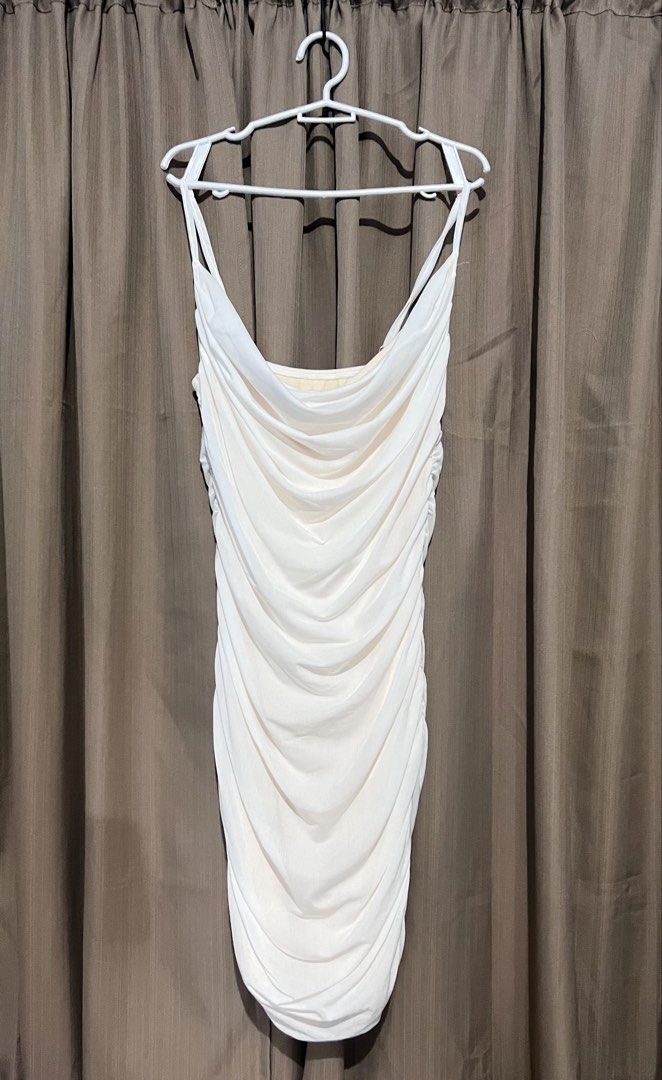 White Ruched Cami Bodycon Dress (Category: Dresses) located in Cainta. Submitted by periwinkle.ph (Listing ID 1468202993, Image 1). Description: - Color: White - Style: Bodycon dress with all-over ruching and draped cowl neckline - Straps: Double strap design on both shoulders - Fit: Form-fitting stretch material that hugs the body - Length: Knee-length - Occasion: Perfect for parties, clubs, and night events - Condition: Clean and ready to wear.