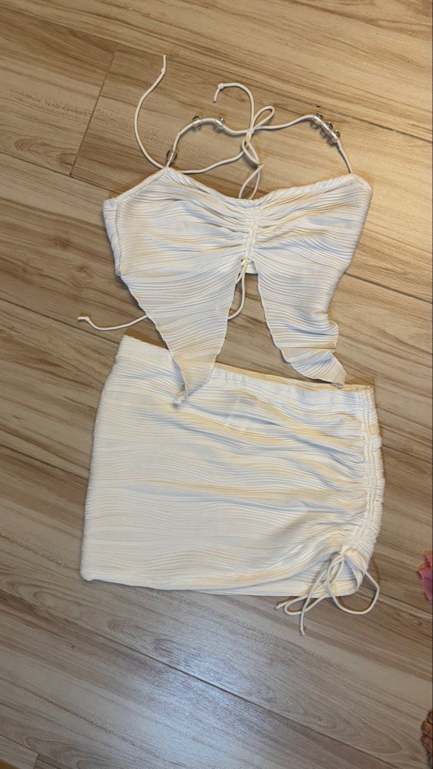 White Ruched Halter Top and Skirt Set (Category: Sets or Coordinates) located in Makati City. Submitted by declutter_forsale (Listing ID 1468204507, Image 1). Description: Fit S-M Stretchy .
