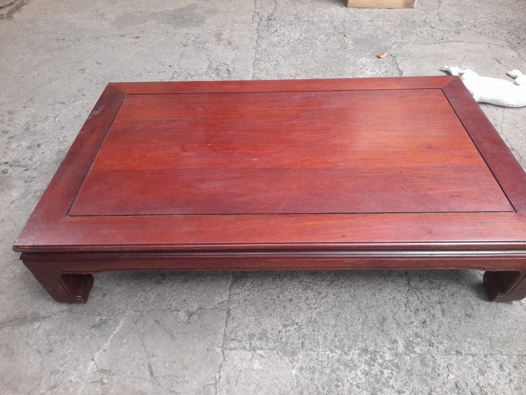 Wooden Coffee Table Low Table Traditional Design (Category: Tables & Sets) located in Valenzuela. Submitted by newbear.425b6e (Listing ID 1468105444, Image 3). Description: - Solid wood coffee table with a rich reddish-brown finish - Low profile legs and traditional recessed panel top with clean edges - Sturdy and durable build, perfect for living rooms or traditional interiors - Condition: Minor surface scuffs from previous use - Available for p