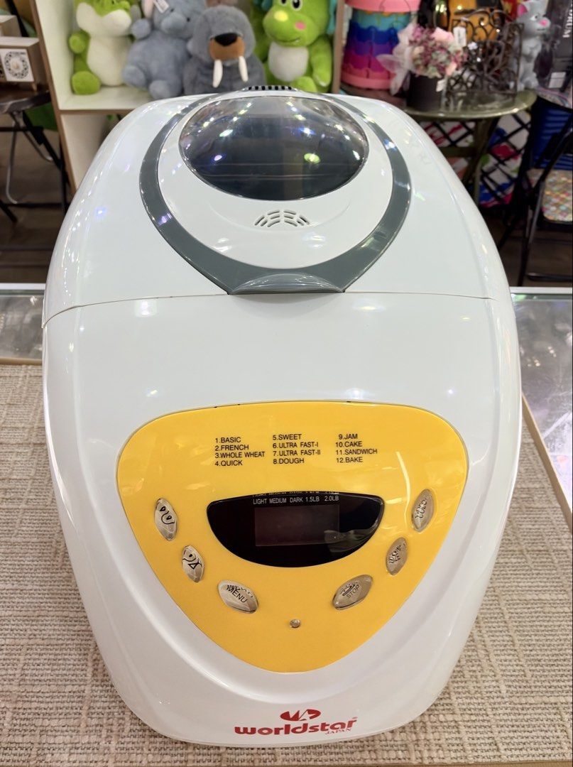 Worldstar Japan Bread Maker Machine Automatic (Category: Breadmakers) located in Kuala Lumpur. Submitted by fauziah_ge3 (Listing ID 1468152221, Image 2). Description: CASH CONVERTERS BTHO CHERAS PRELOVE WORLDSTAR BM1188 BREAD MAKER 600 W - Color: White exterior with a vibrant yellow control panel and digital display - Programs: 12 versatile settings (Basic, Whole Wheat, French, Sweet, Dough, and more) - Features: Top viewing window to check bakin